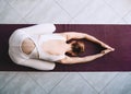 Young woman practicing yoga on yoga mat indoors Royalty Free Stock Photo