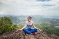 Young woman practicing yoga and meditation in mountains during luxury yoga retreat in Thailand, Asia