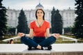 Young woman practicing yoga and meditation in park.Urban relaxation. Female meditating in a public park.Morning routine.Stress Royalty Free Stock Photo