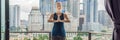 Young woman is practicing yoga in the morning on her balcony with a panoramic view of the city and skyscrapers BANNER, long format Royalty Free Stock Photo