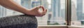 Young woman is practicing yoga in the morning on her balcony with a panoramic view of the city and skyscrapers BANNER, long format Royalty Free Stock Photo