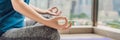 Young woman is practicing yoga in the morning on her balcony with a panoramic view of the city and skyscrapers BANNER, long format Royalty Free Stock Photo