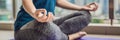 Young woman is practicing yoga in the morning on her balcony with a panoramic view of the city and skyscrapers BANNER Royalty Free Stock Photo