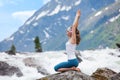 Young woman is practicing yoga at mountain river Royalty Free Stock Photo