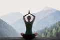 Young woman practicing yoga in mountains at sunset, meditation concept Royalty Free Stock Photo