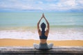 Young woman practicing yoga in the nature, Female happiness, Young healthy woman practicing yoga on the beach at sunset Royalty Free Stock Photo