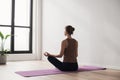 Young woman practicing yoga near floor window in yoga studio, Young girl meditating at home Royalty Free Stock Photo