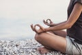 Young woman practicing yoga near the sea. Harmony and meditation concept.