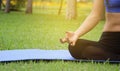 Young woman practicing yoga in the park, stretching and flexibility, practiced for health and relaxation