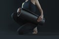 Fit woman practicing yoga pose doing stretching . sport workout fitness. yoga mat and leggins dark black background