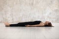 Young woman practicing yoga, Savasana, Dead Body pose, Corpse Royalty Free Stock Photo