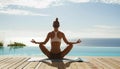 Young woman practicing yoga by a swimming pool with ocean in the background. Royalty Free Stock Photo