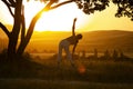 Young woman is practicing yoga in Tree Pose (Vrikshasana) pose at mountain Royalty Free Stock Photo