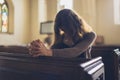 Young woman praying in church Royalty Free Stock Photo