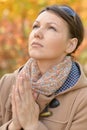 Portrait of young woman praying in park Royalty Free Stock Photo