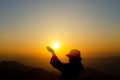 Young woman praying, meditating in harmony and peace at sunset. Religion, spirituality, prayer, peace Royalty Free Stock Photo