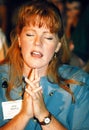 A young woman prays during a religious service