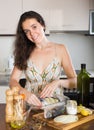 Young woman prepare fish dorado in frying pan Royalty Free Stock Photo