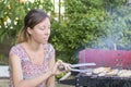 Young woman preparing barbecue Royalty Free Stock Photo