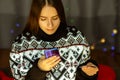 Young woman preparing for christmas, shopping online from credit card, choosing gifts on sale