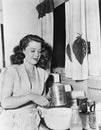 Young woman preparing food in the kitchen Royalty Free Stock Photo