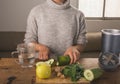 Young woman preparing ingredients to prepare green juice, apple, cucumber, spinach, ginger, healthy breakfast 6