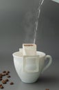 Young woman preparing a modern filter coffee in a drip bag at home. Step 3: Pour hot water