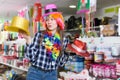 Young woman choosing funny headdresses Royalty Free Stock Photo