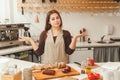 Young woman is preparing some food in the kitchen. Royalty Free Stock Photo