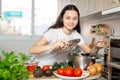 Young woman preparing soup in saucepan in kitchen Royalty Free Stock Photo