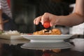 Young woman preparing tasty salad during cooking classes in restaurant kitchen, closeup Royalty Free Stock Photo