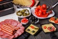 Young woman is preparing a traditional Swiss cheese raclette