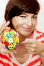Young woman presents colorful easter egg Royalty Free Stock Photo