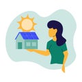 Young woman presents a house with a solar panel Royalty Free Stock Photo