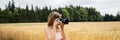 Young woman with professional dslr camera taking photos outside in beautiful nature Royalty Free Stock Photo