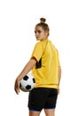 Young woman, professional female football, soccer player in yellow uniform posing with ball isolated over white studio Royalty Free Stock Photo