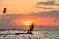 Young woman professional kiter performs ride beautiful background of the sunset and sea Royalty Free Stock Photo