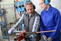 Young woman in professional training of plumbery