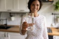 Young woman propose to start morning from glass of water