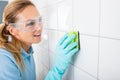 Woman Cleaning The White Tile Of The Wall Royalty Free Stock Photo