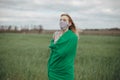 Young woman in protective mask in field. Lady quarantine in the village. Girl and quarantine . Covid-19. Europe Royalty Free Stock Photo