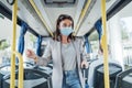 Young woman in protective mask traveling in the bus Royalty Free Stock Photo