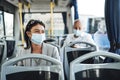 Young woman in protective mask traveling in the bus Royalty Free Stock Photo