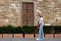 Young woman with protective masks in square next to David sculpture. Tourists wearing face masks during covid 19 quarantine in Ita