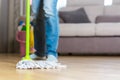 Woman in protective gloves using a wet-mop while cleaning floor Royalty Free Stock Photo