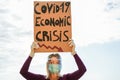 Young woman protest against Covid-19 economic crisis wearing, latex gloves, face and eye protection mask - Global social disaster
