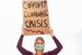 Young woman protest against Covid-19 economic crisis wearing latex gloves and face mask - Global social disaster and pandemic