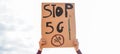 Young woman protest against 5g and cell towers - Electromagnetic pollution and internet of things concept - Focus on banner