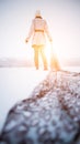 Young woman pulling her scarf behind her on snow