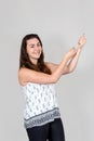Young woman pulling imaginary rope with her hands Royalty Free Stock Photo